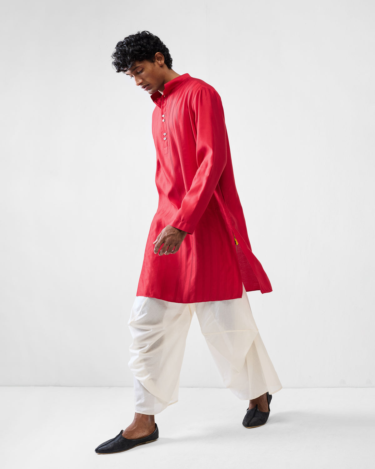 Person walking in a red Long Pleated Kurta showing the side slit.