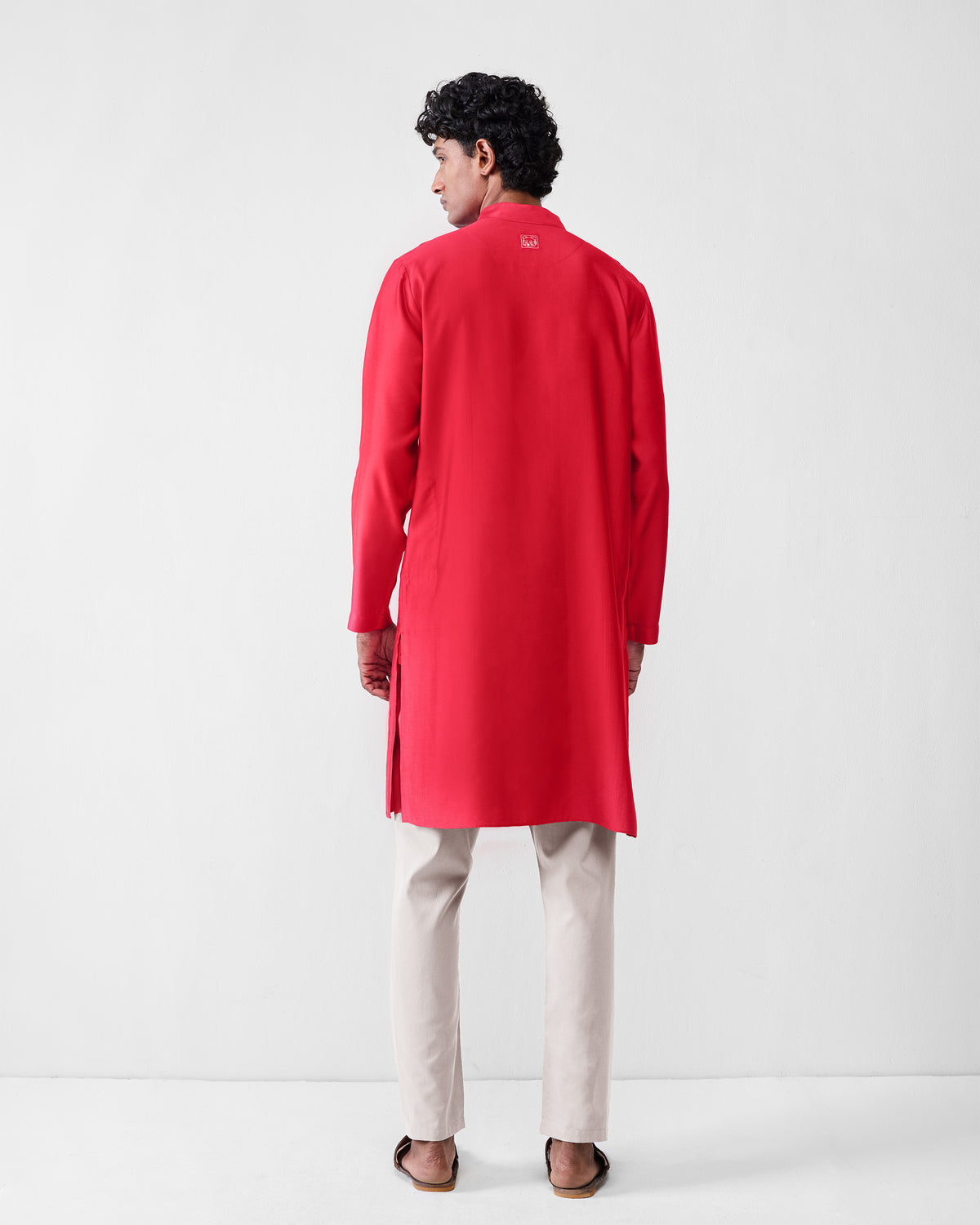 Back of a red Long Pleated Kurta worn by a person.