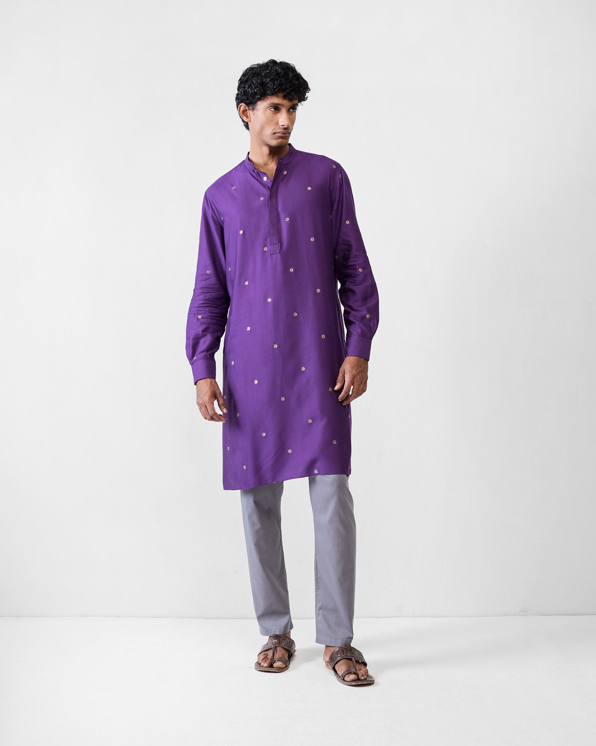 Person wearing a purple Neckband Kurta with scattered light motifs.