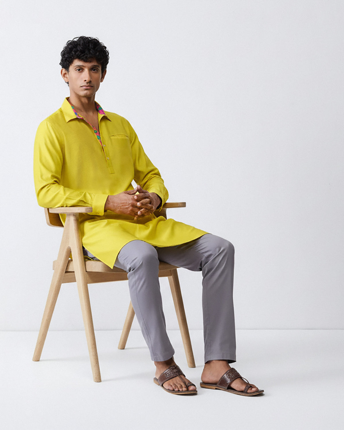 Person wearing a chartreuse Bouquet kurta with patterned collar lining.