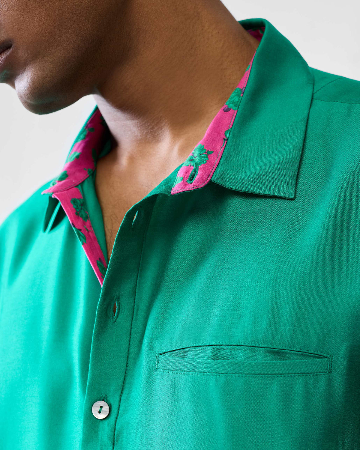 Close-up of an emerald green Bouquet kurta collar with pink floral lining.