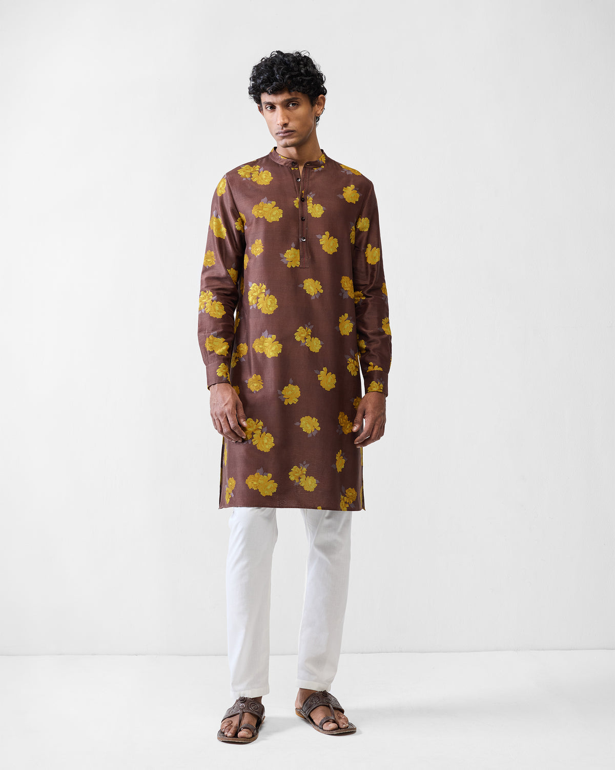 Person wearing a brown Astral kurta with yellow peony print.