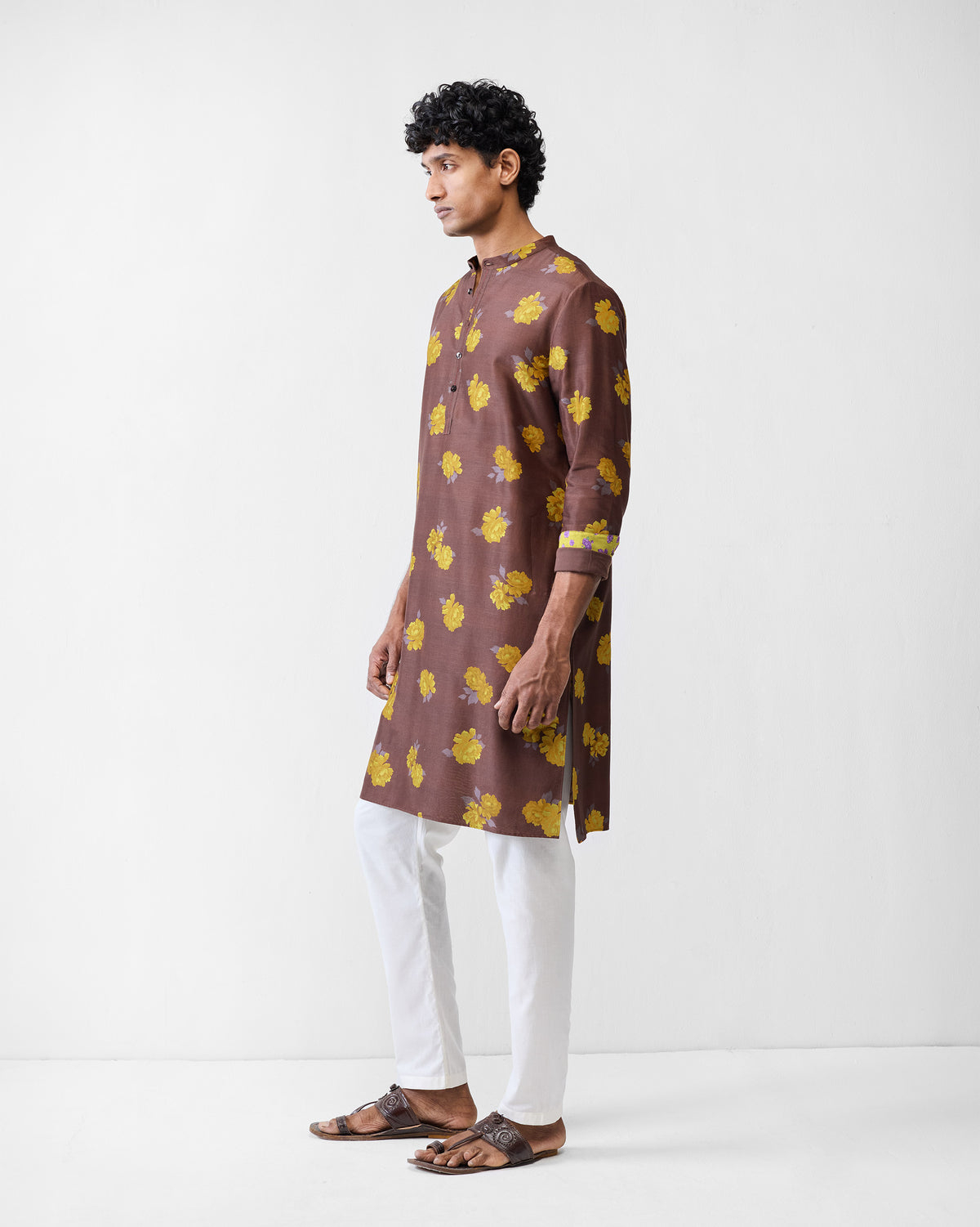 Side view of a brown Astral kurta with yellow floral print.