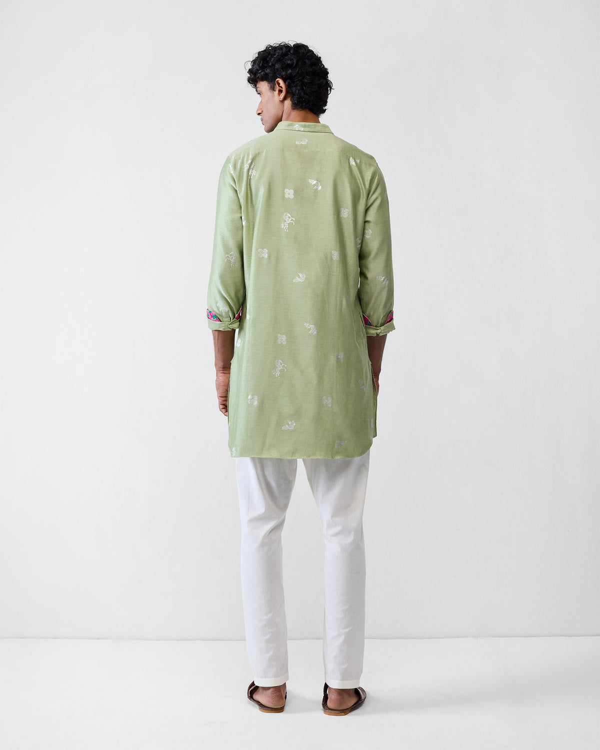 Back of a mint Fort kurta with white motifs and colourful cuff lining.