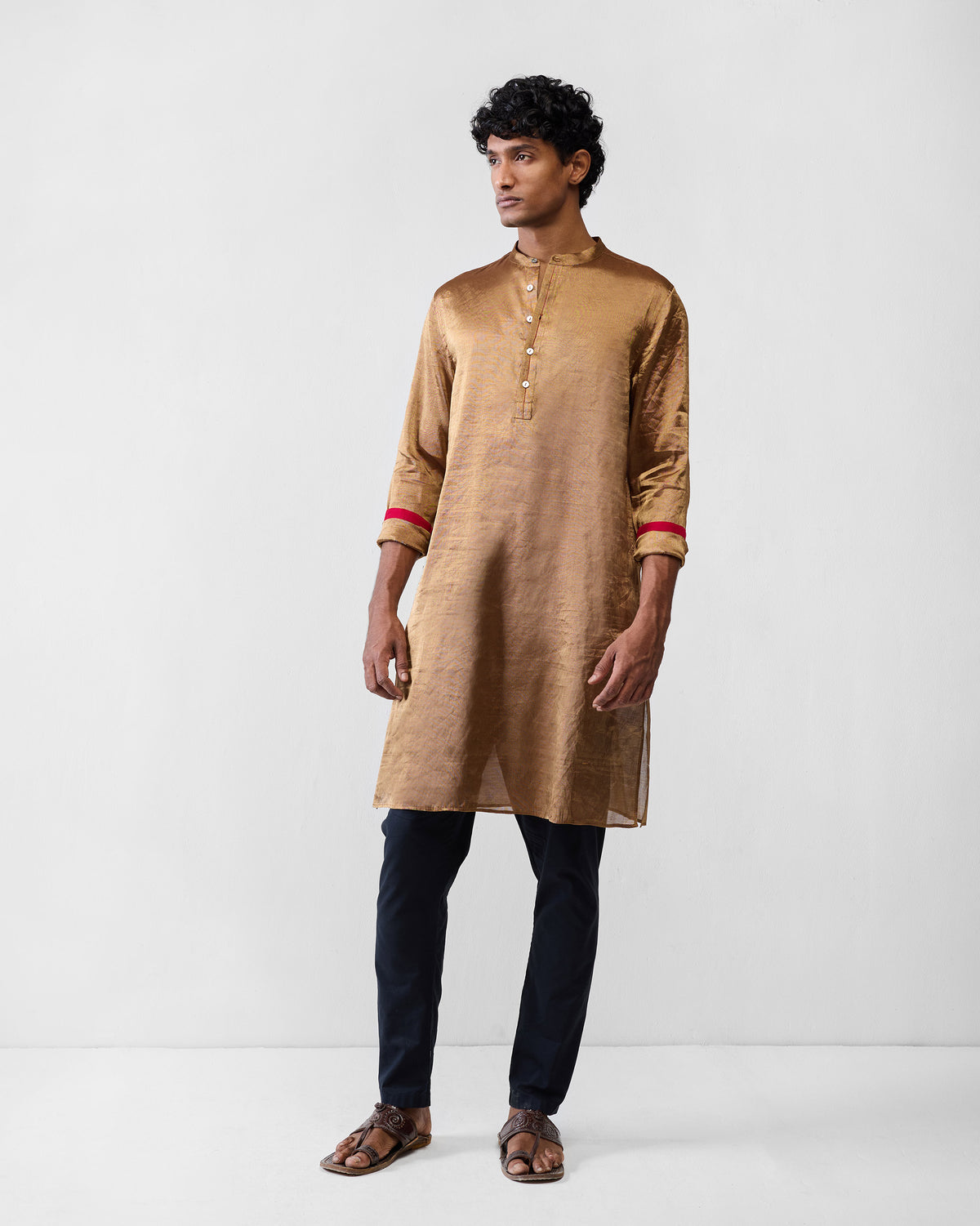 Person wearing a gold Chandni Chowk kurta.