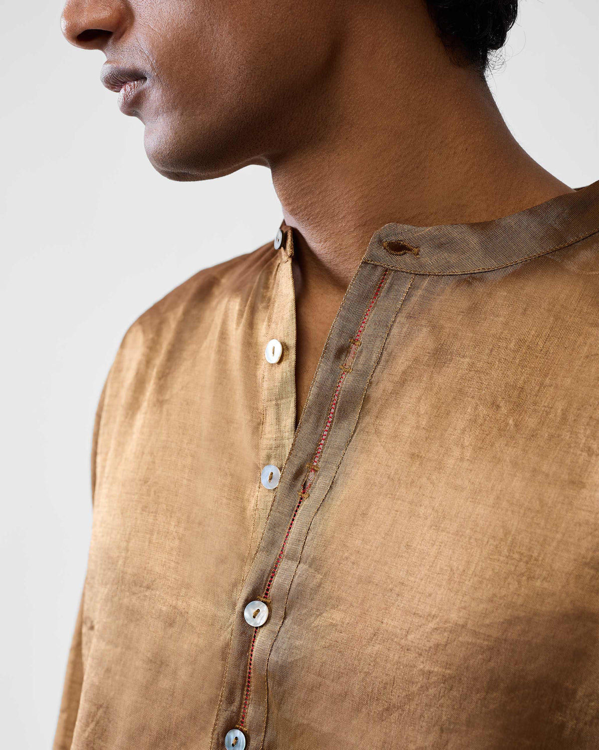 Close-up of a gold Chandni Chowk kurta collar and placket.
