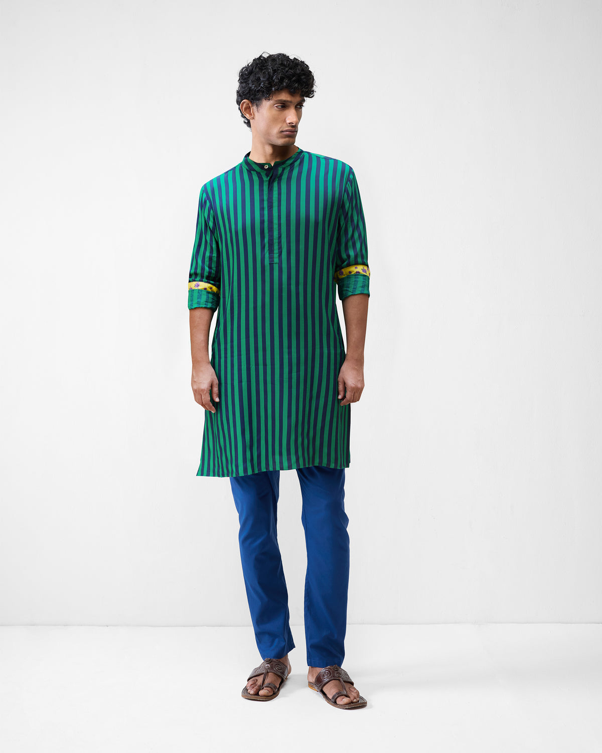 Person wearing a green and navy striped Gala Kurta with yellow cuff lining.