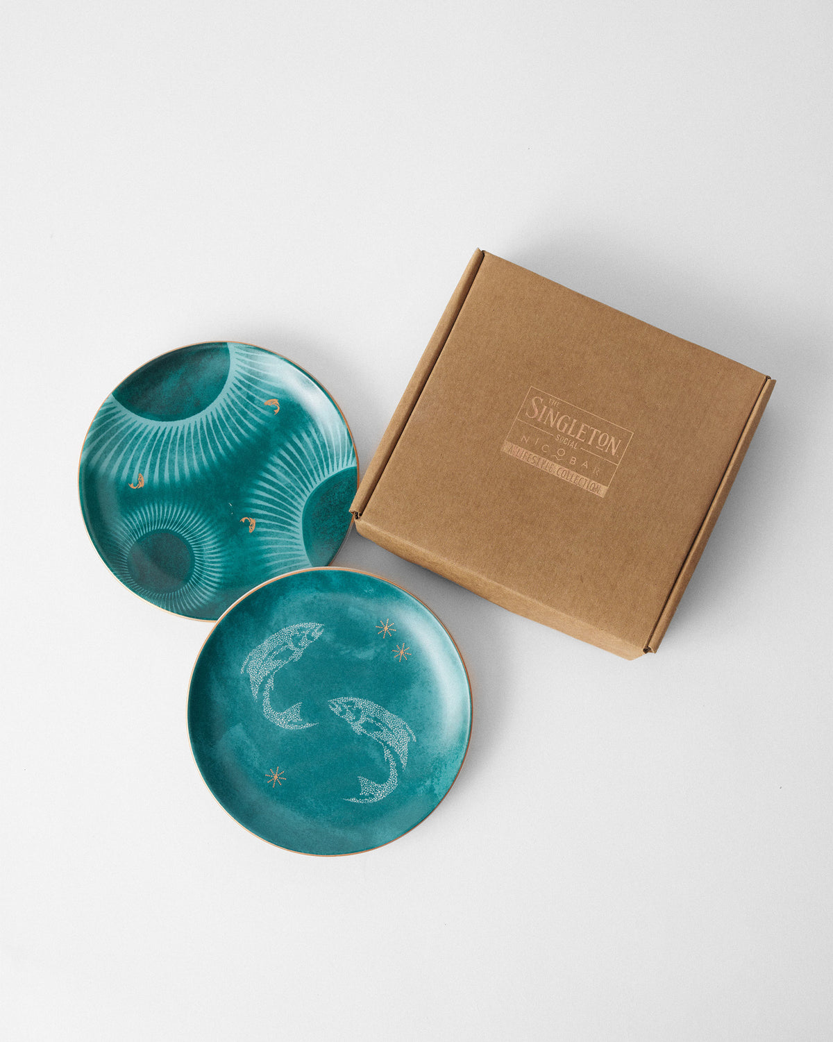 Caden quarter plates beside a Singleton X Nicobar kraft gift box.