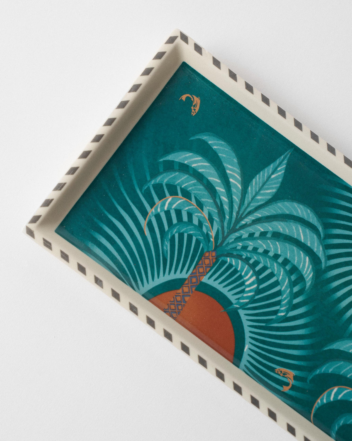 Close-up of a palm and orange sun print on the Caden cookie tray.