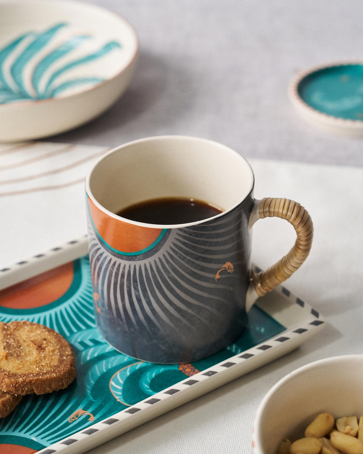 Cascade Straight Mug filled with coffee, showing grey fan rays and an orange sun.