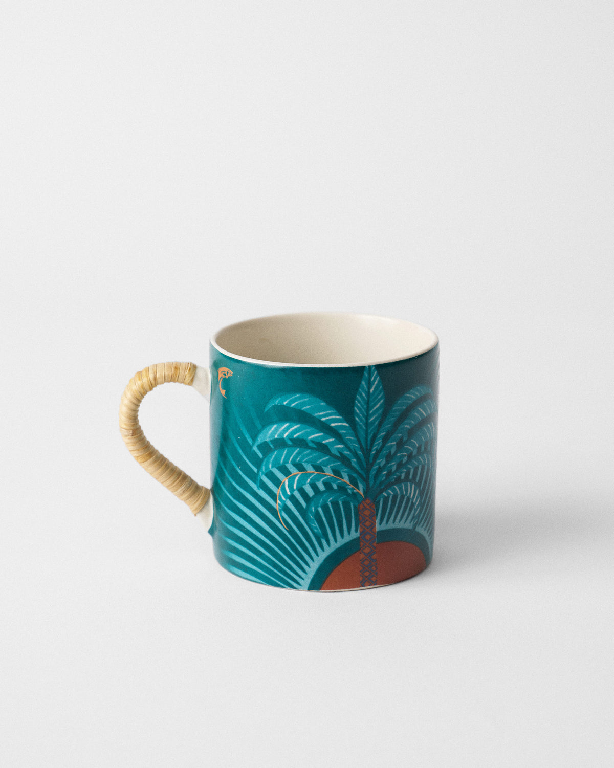 Caden Straight Mug turned to show a tall teal palm and its rattan handle.