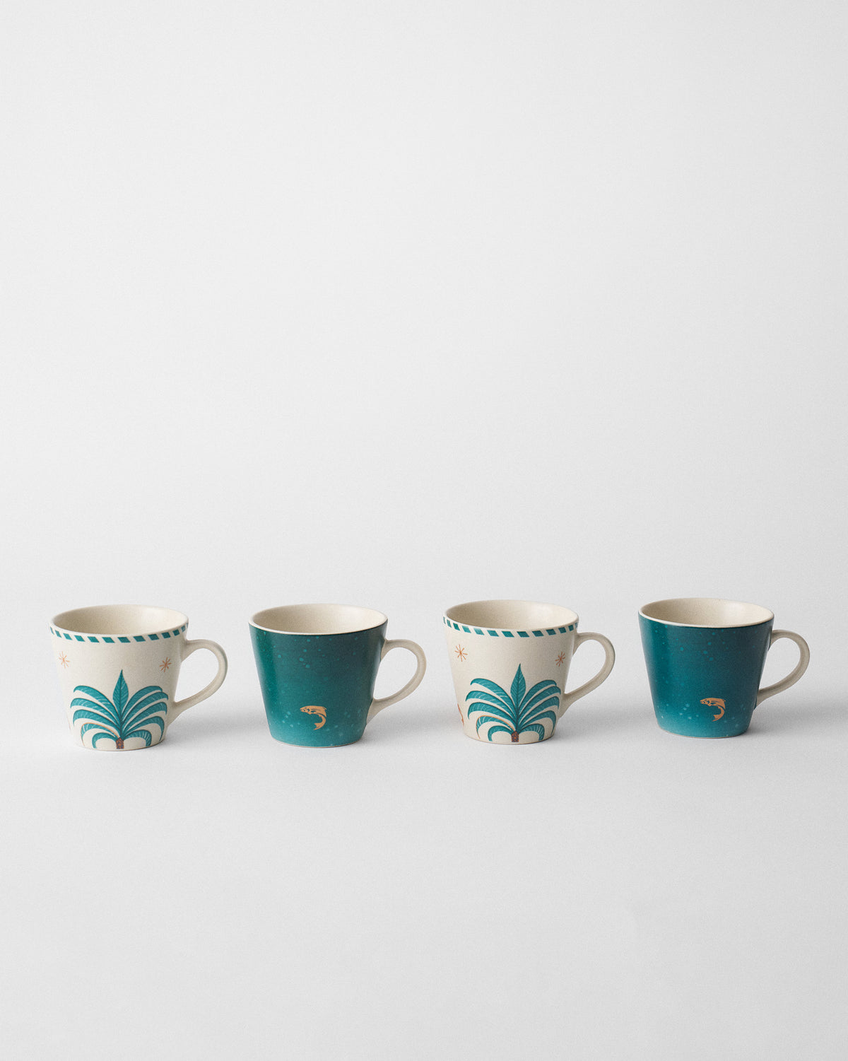 Set of four Aluna Espresso Mugs with teal palm and fish designs.