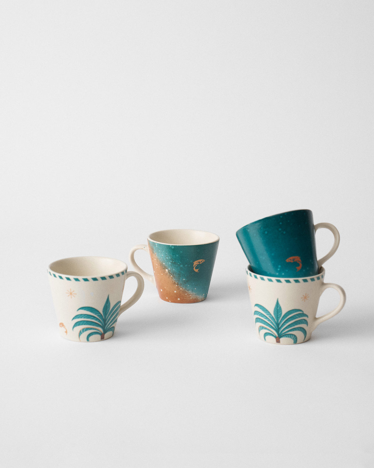 Aluna Espresso Mug set with cream palm and teal fish designs.
