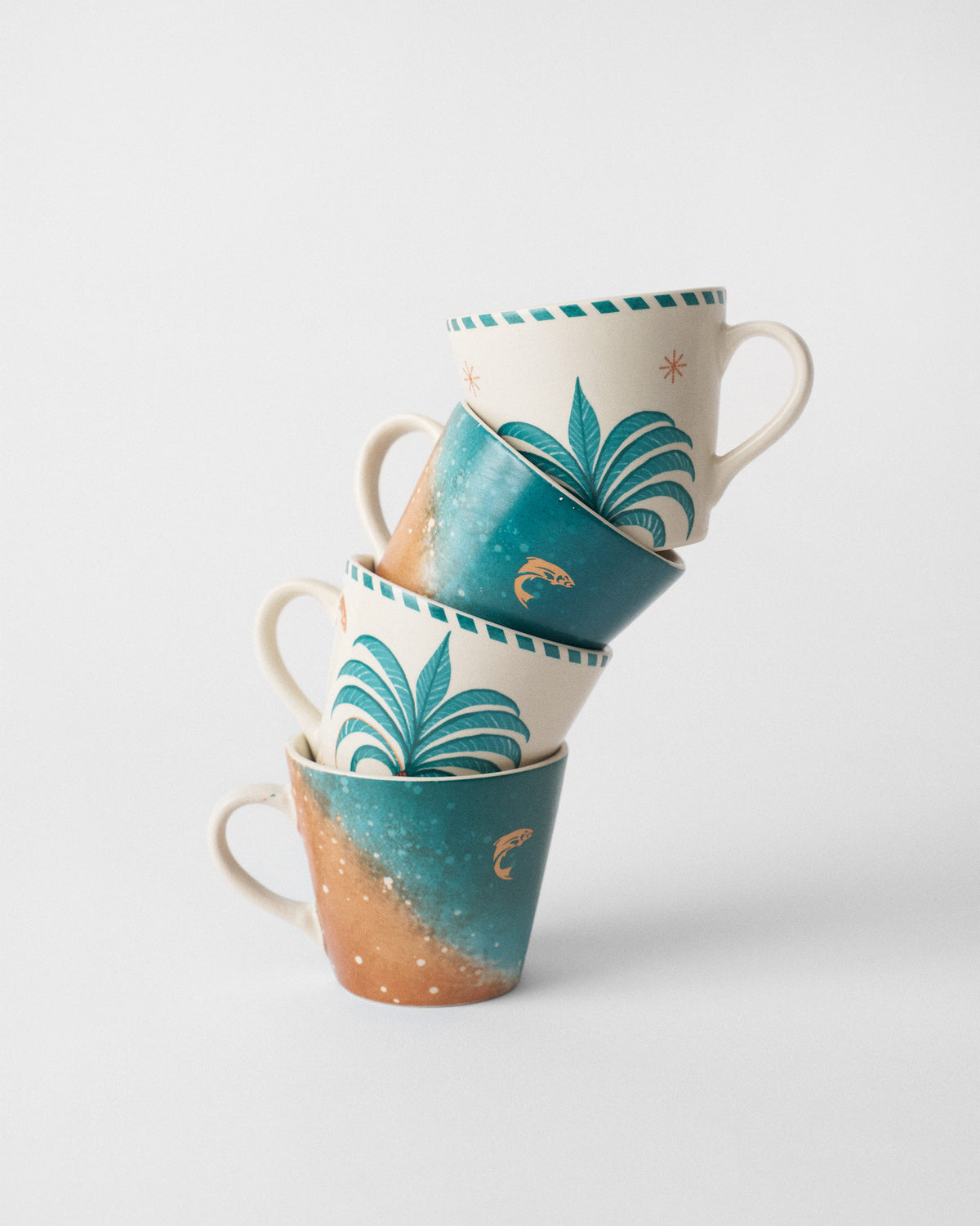 Stack of four Aluna Espresso Mugs alternating palm and teal designs.
