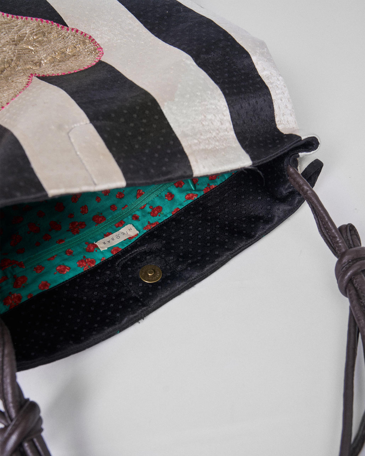 Close-up of the Nomad Tote showing teal floral lining.