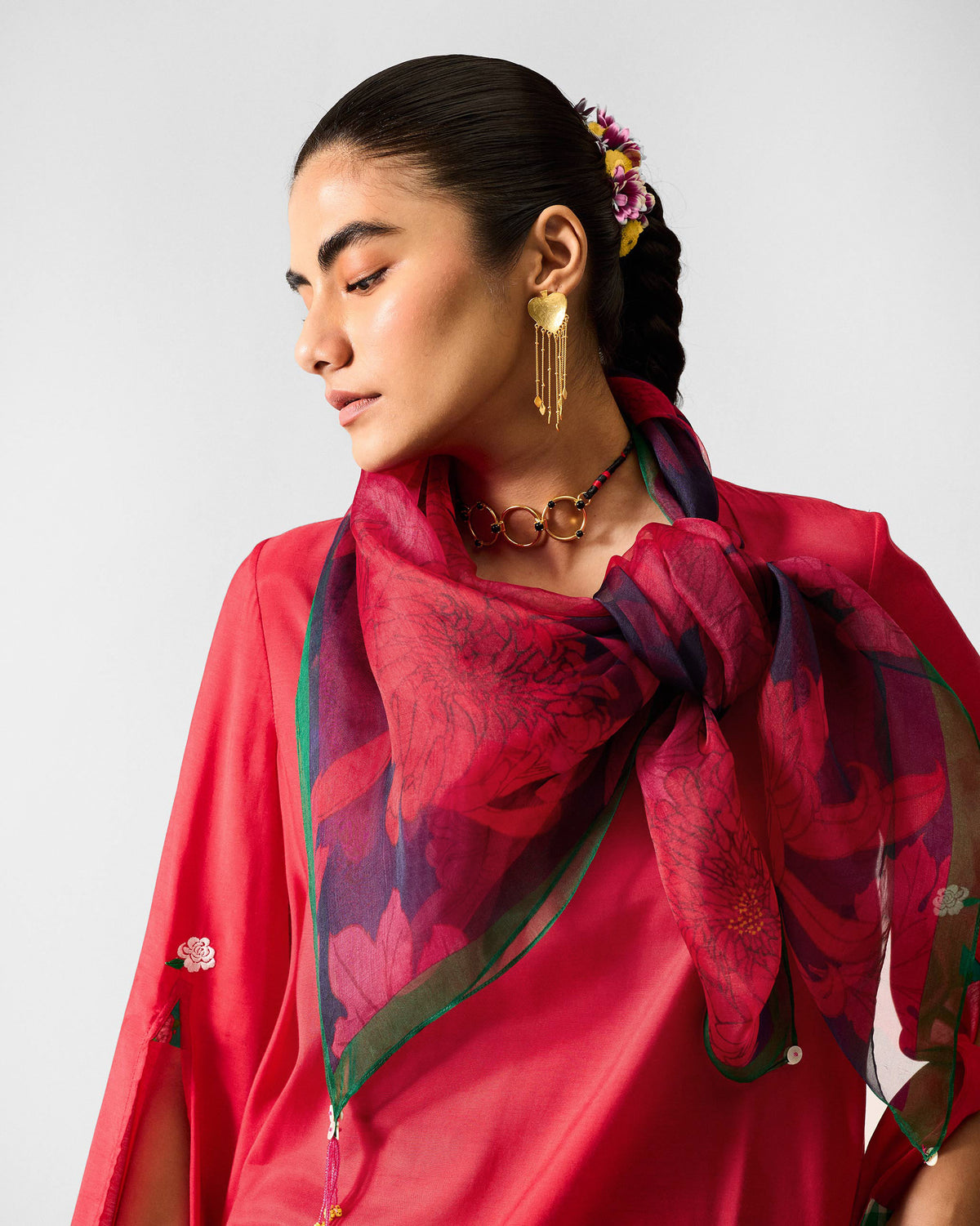Person wearing the Chrysanthemum Bloom Scarf knotted at the neck.