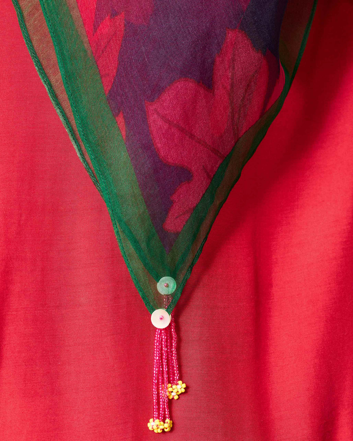 Close-up of the Chrysanthemum Bloom Scarf's green edge and beaded tassels.
