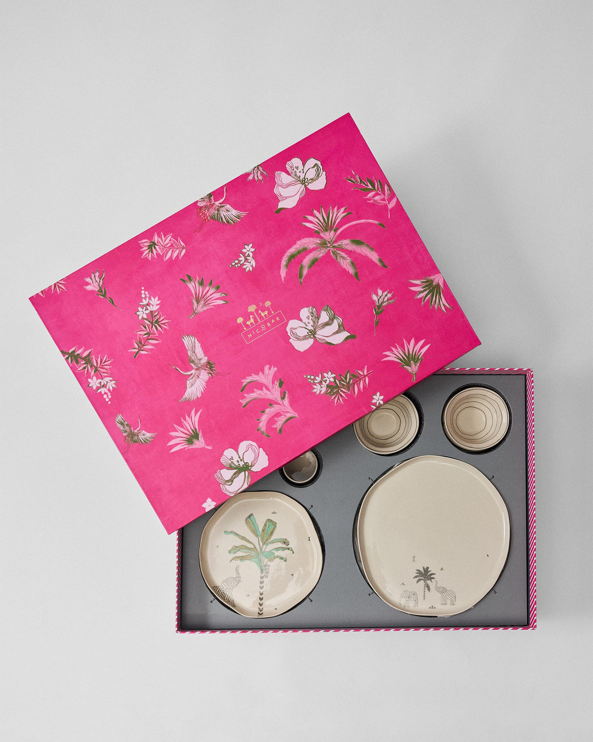 Ceylon Trail Dinner Gift Set in its pink box, with the lid tilted aside to show the plates.