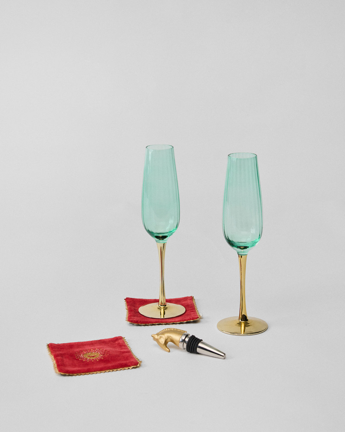 Prance champagne flutes with gold stems, velvet coasters, and stopper.