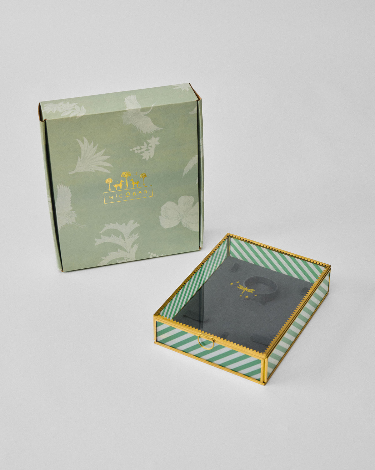 Closed Trove glass jewellery box beside its sage Nicobar gift box.
