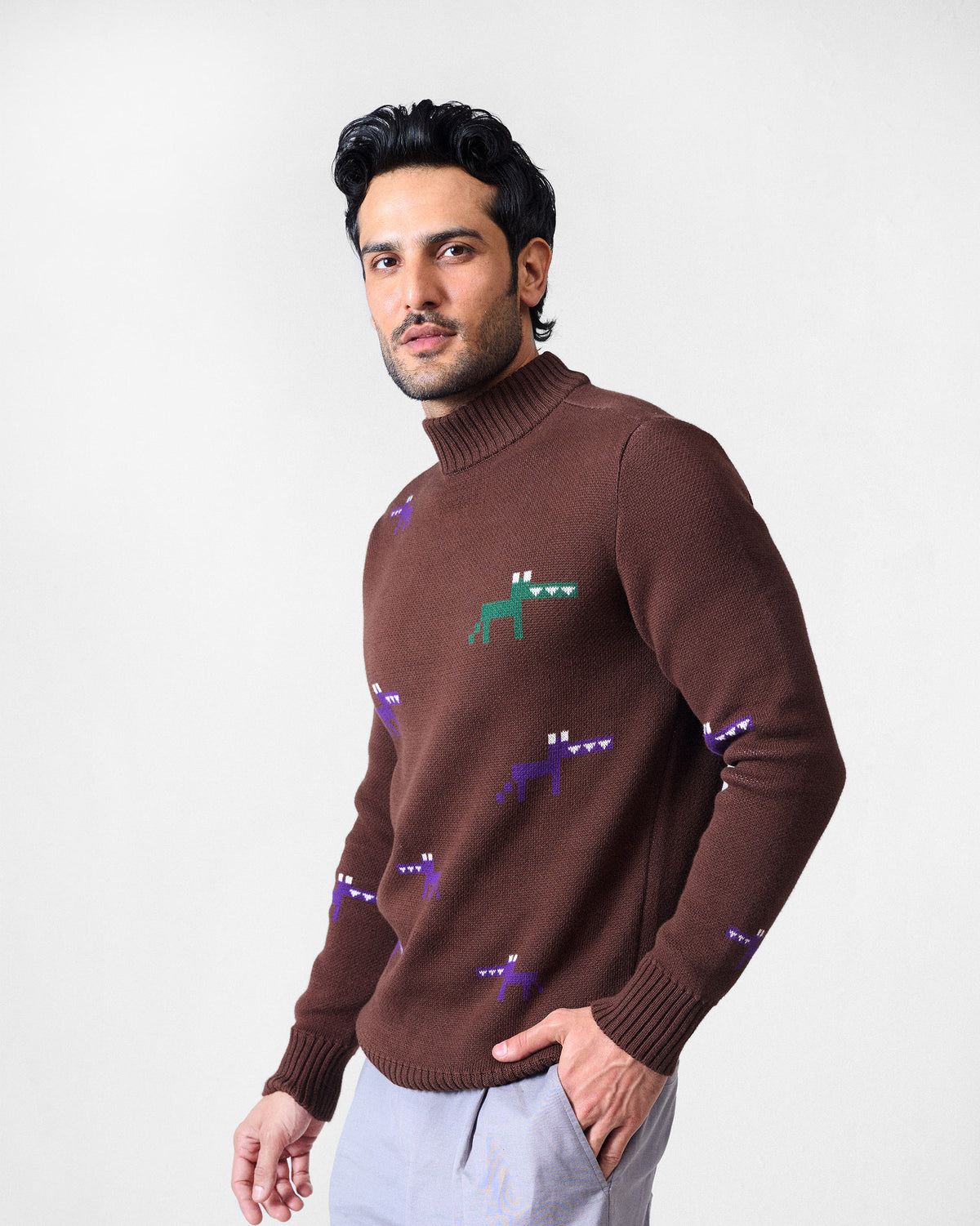 Brown crew neck sweater with purple and green pixel animal motifs.