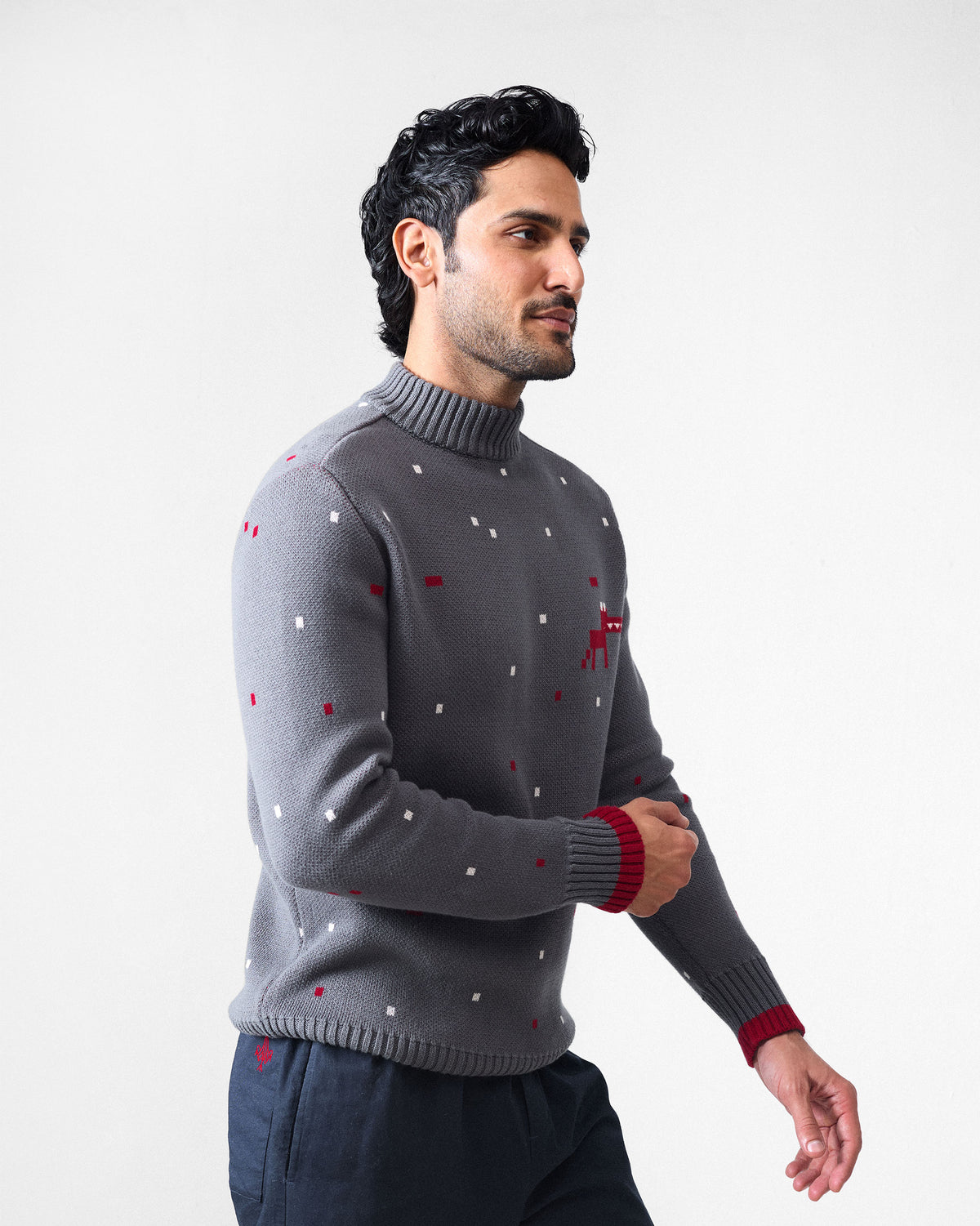 Person wearing a charcoal Crew Neck sweater with a red pixel animal on the chest.