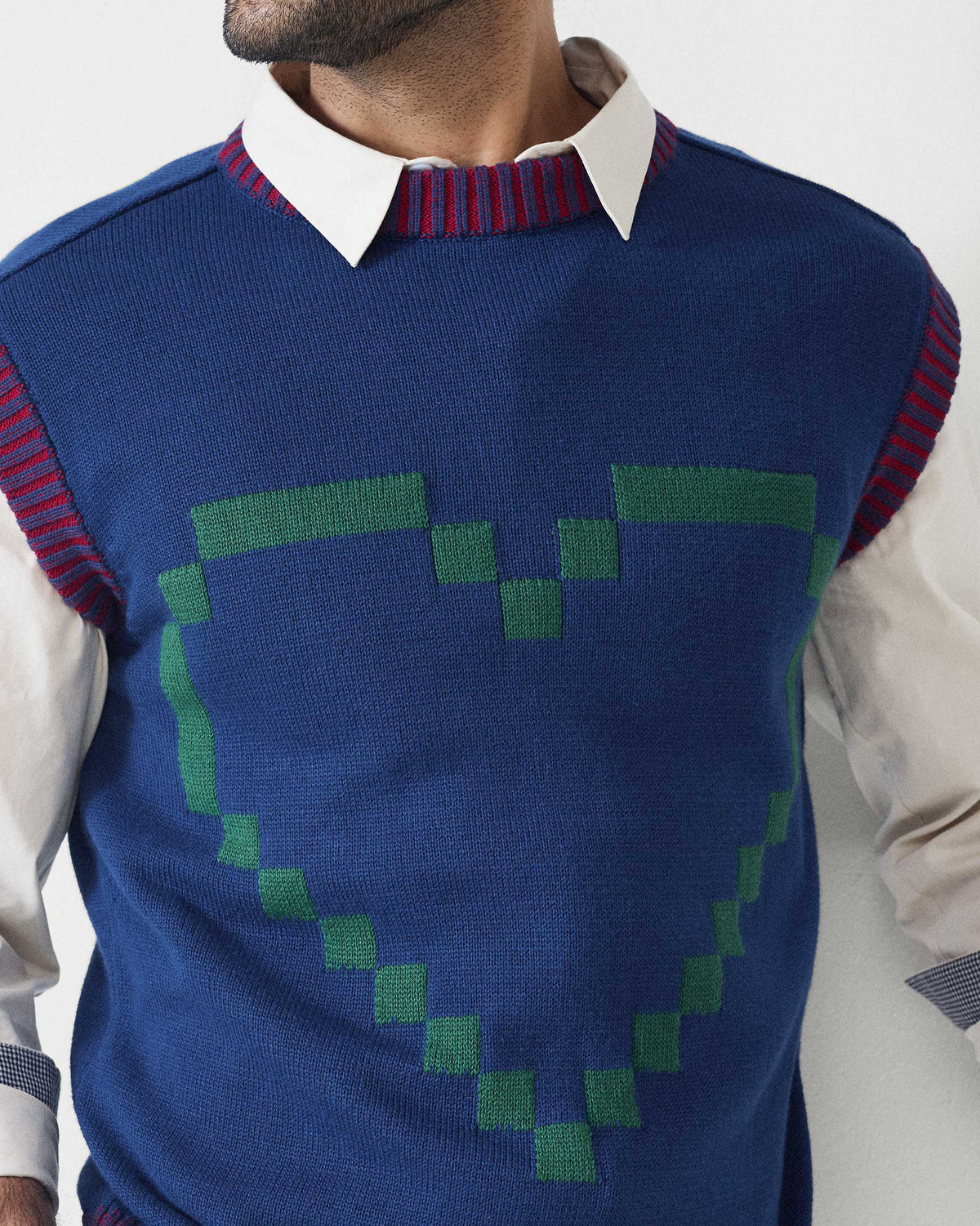 Close-up of a navy Pixel Sweater showing a green pixel heart on the chest.