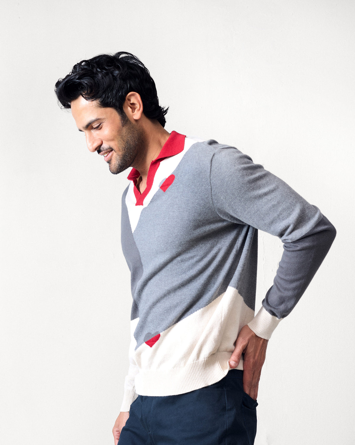 Grey Dom Sweater with diagonal colour blocks and a red polo collar.