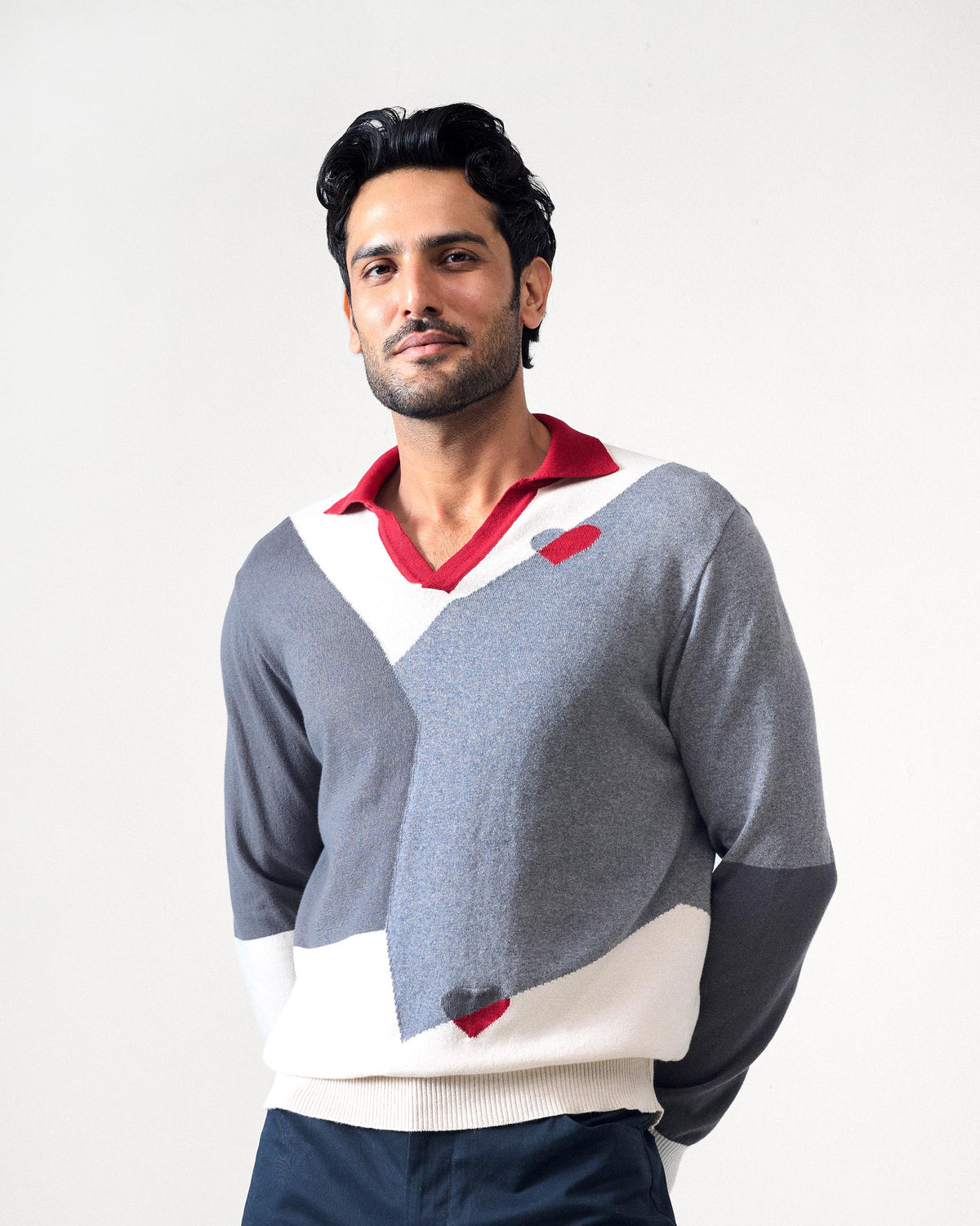 Grey Dom Sweater with cream panels, a red collar, and a red heart.