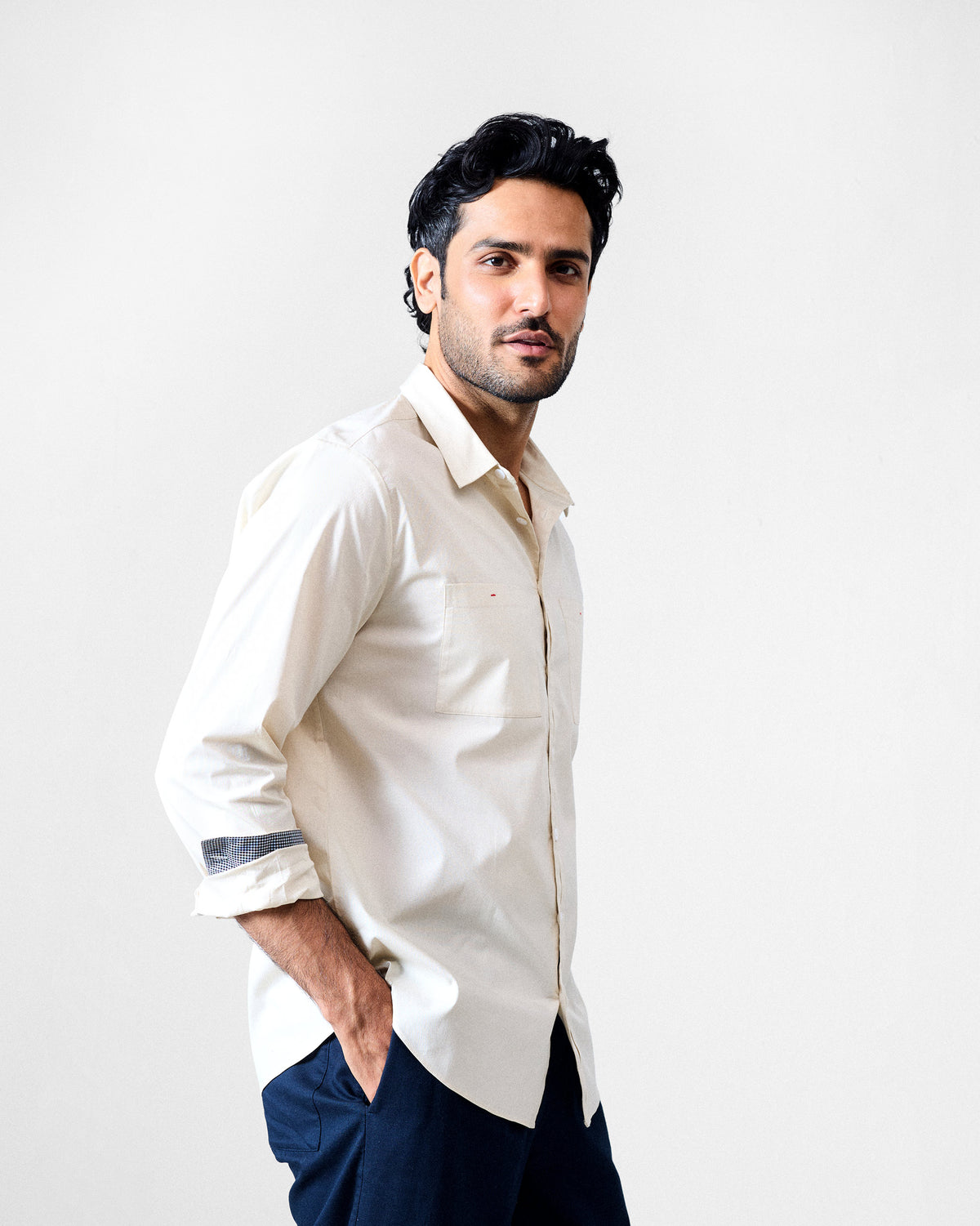 Ivory Abe shirt worn open at the collar with a chest pocket.