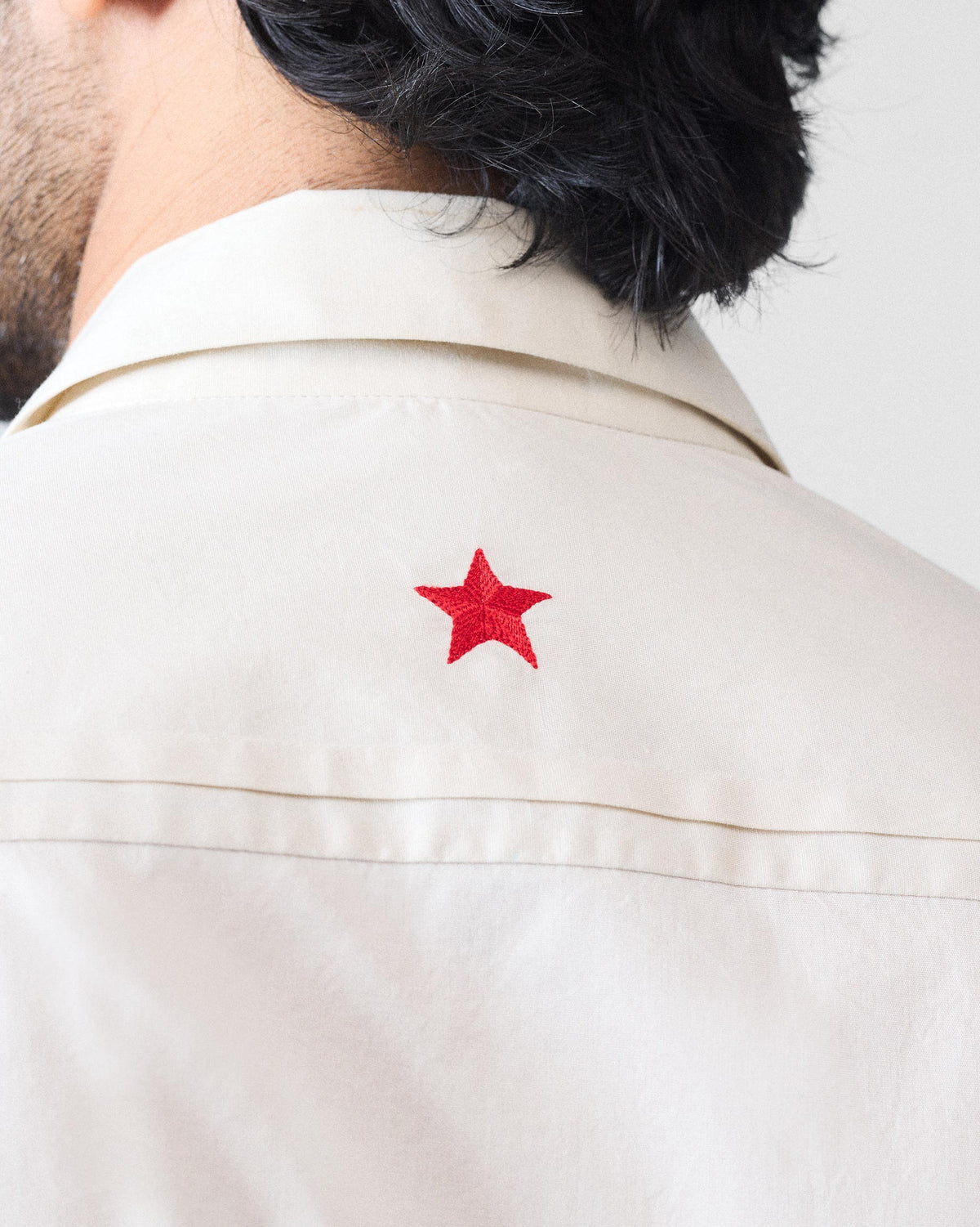 Red star embroidery on the ivory Abe shirt back yoke.