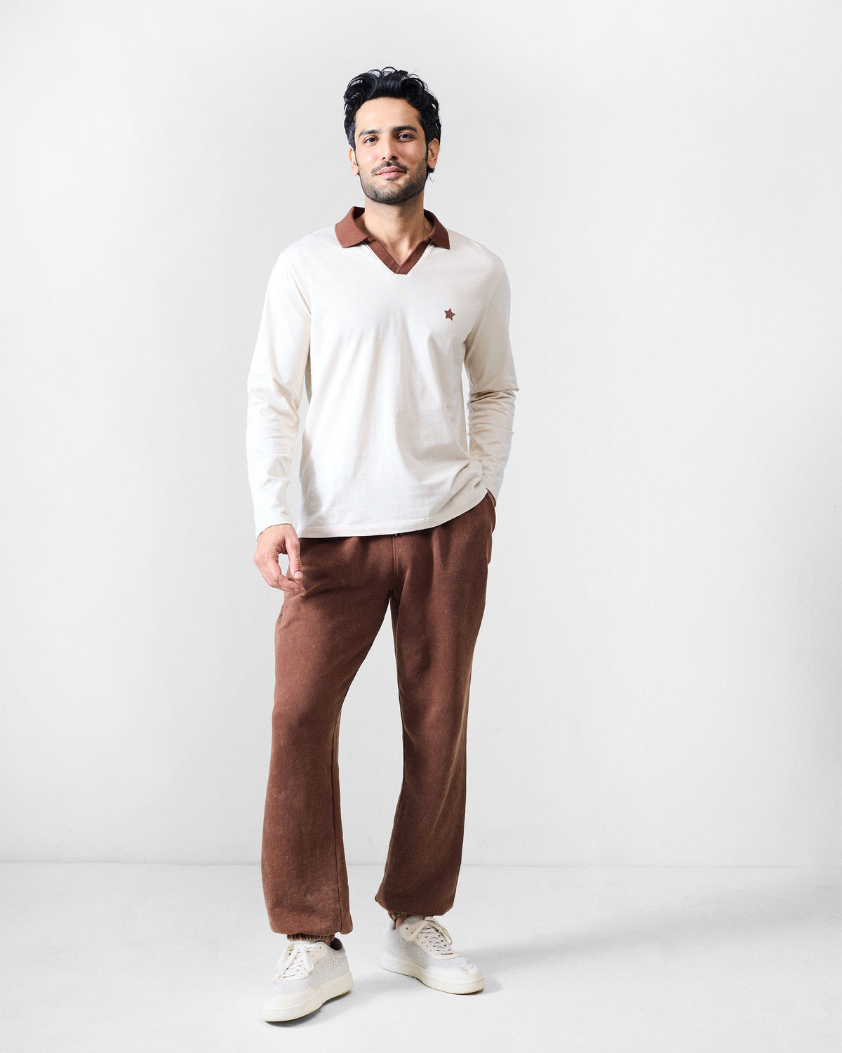 Person wearing brown Drift bottoms with a relaxed straight leg.