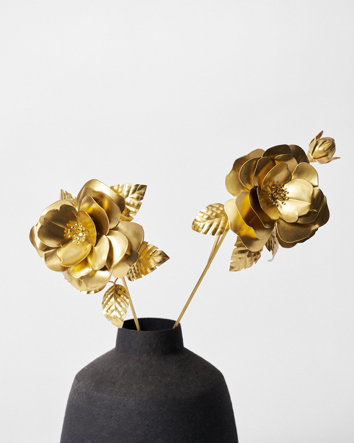 Close-up of gold rose home accents showing layered petals and stamens.