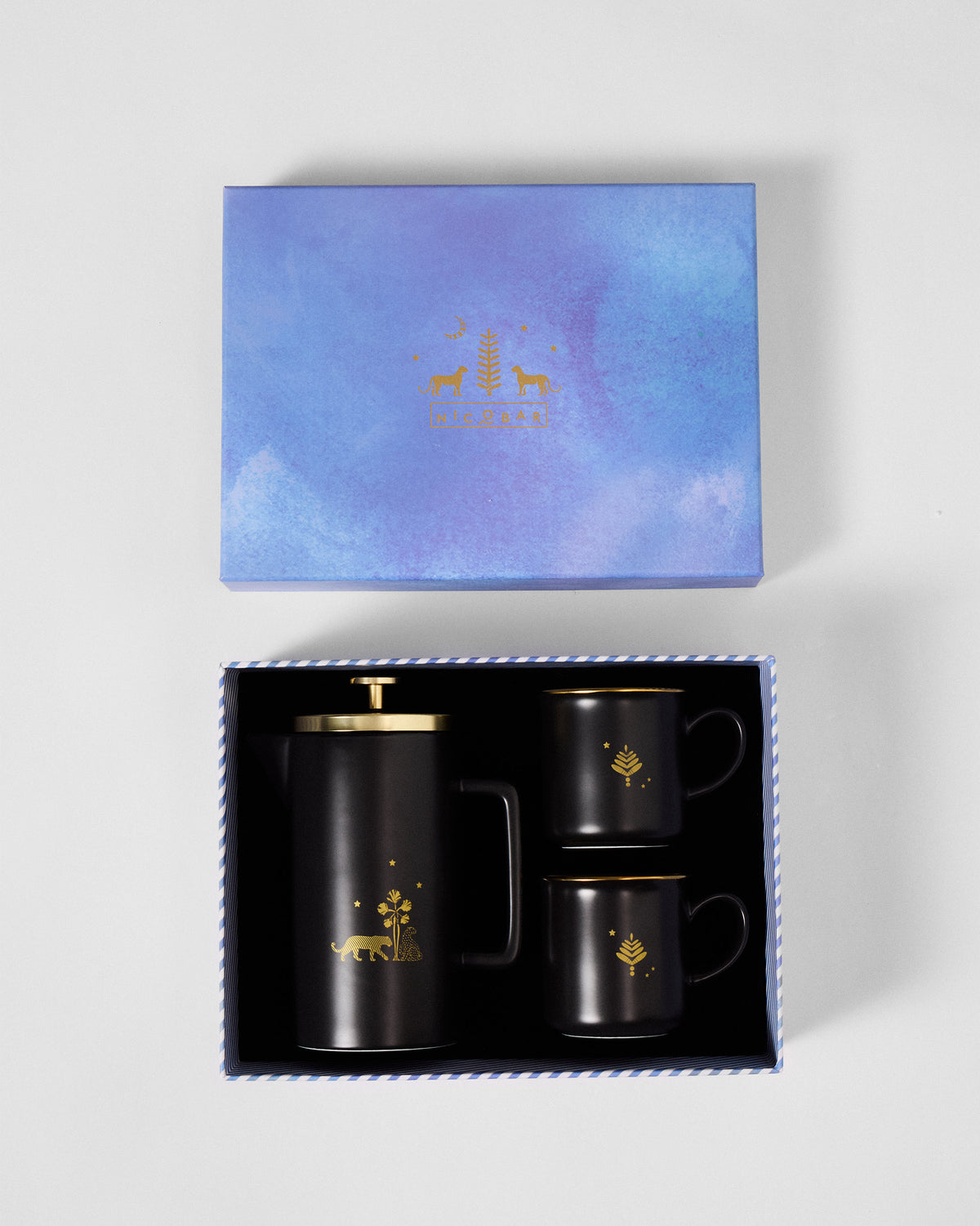 Sindhuraa coffee press and mugs packed in their open Nicobar gift box.