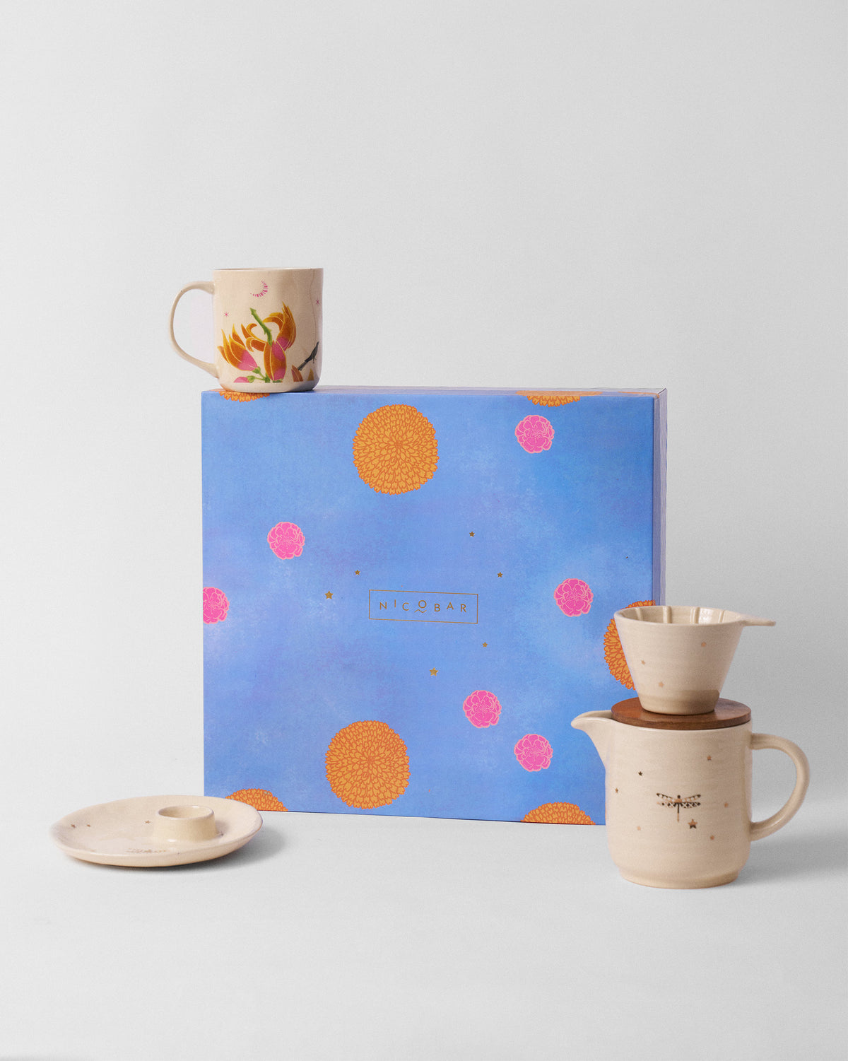 Aaranya breakfast gift set with cream ceramics in front of a blue floral Nicobar box.
