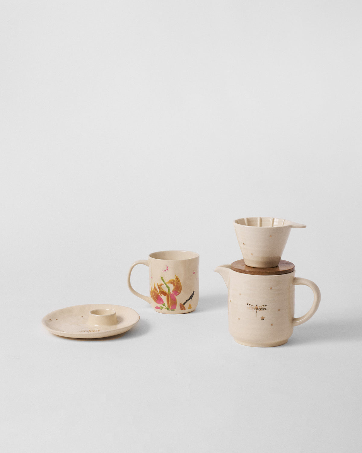 Cream Aaranya mug, pitcher with wooden lid and dripper, and a small ceramic dish.