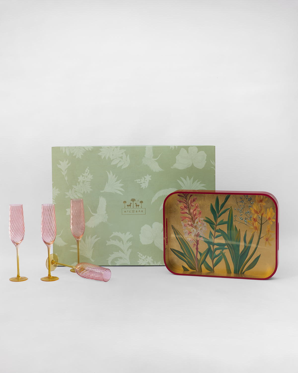 Botanical Barware Set with pink flutes, floral tray, and sage gift box.