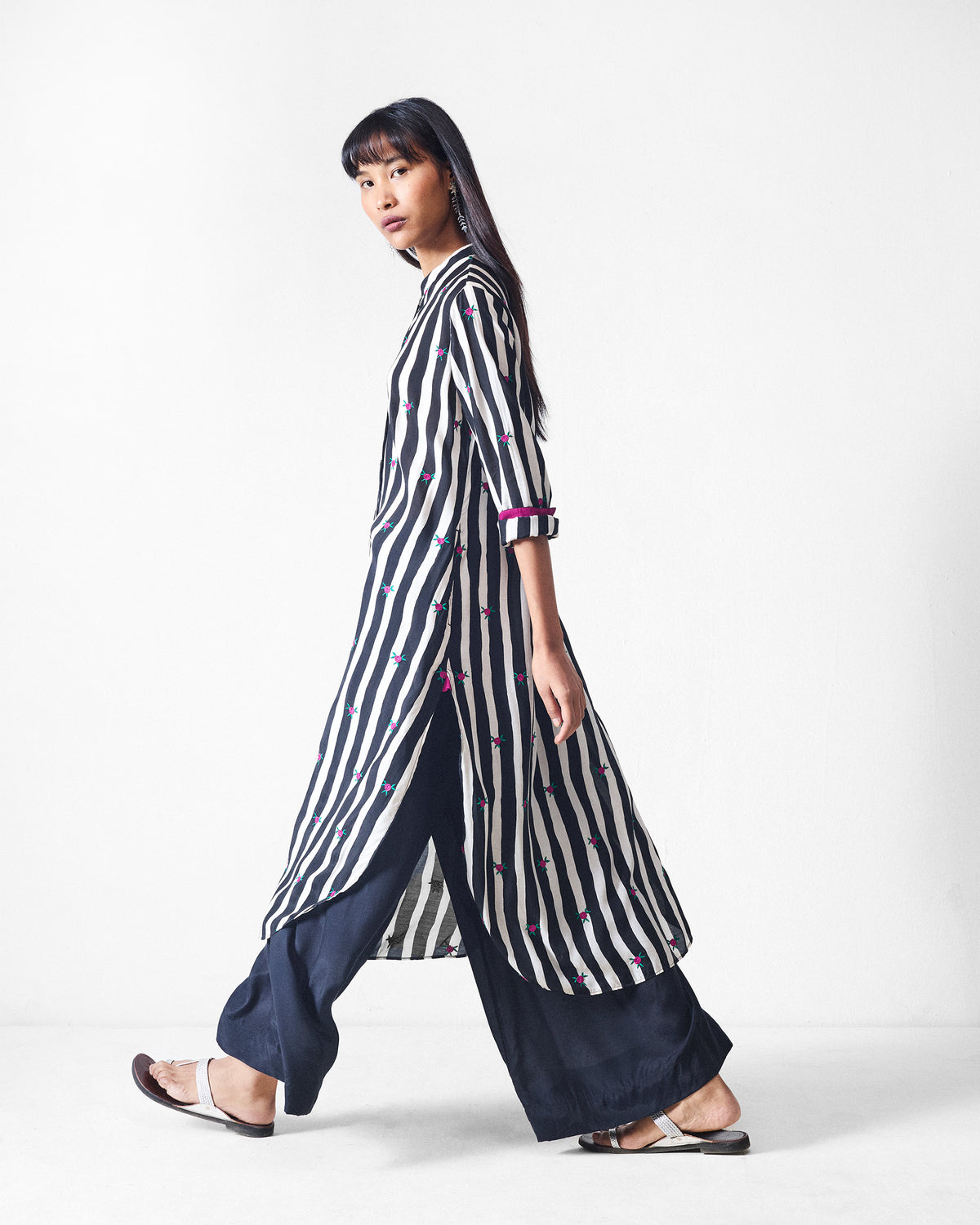 Side view of a black and beige striped long kurta with side slits.