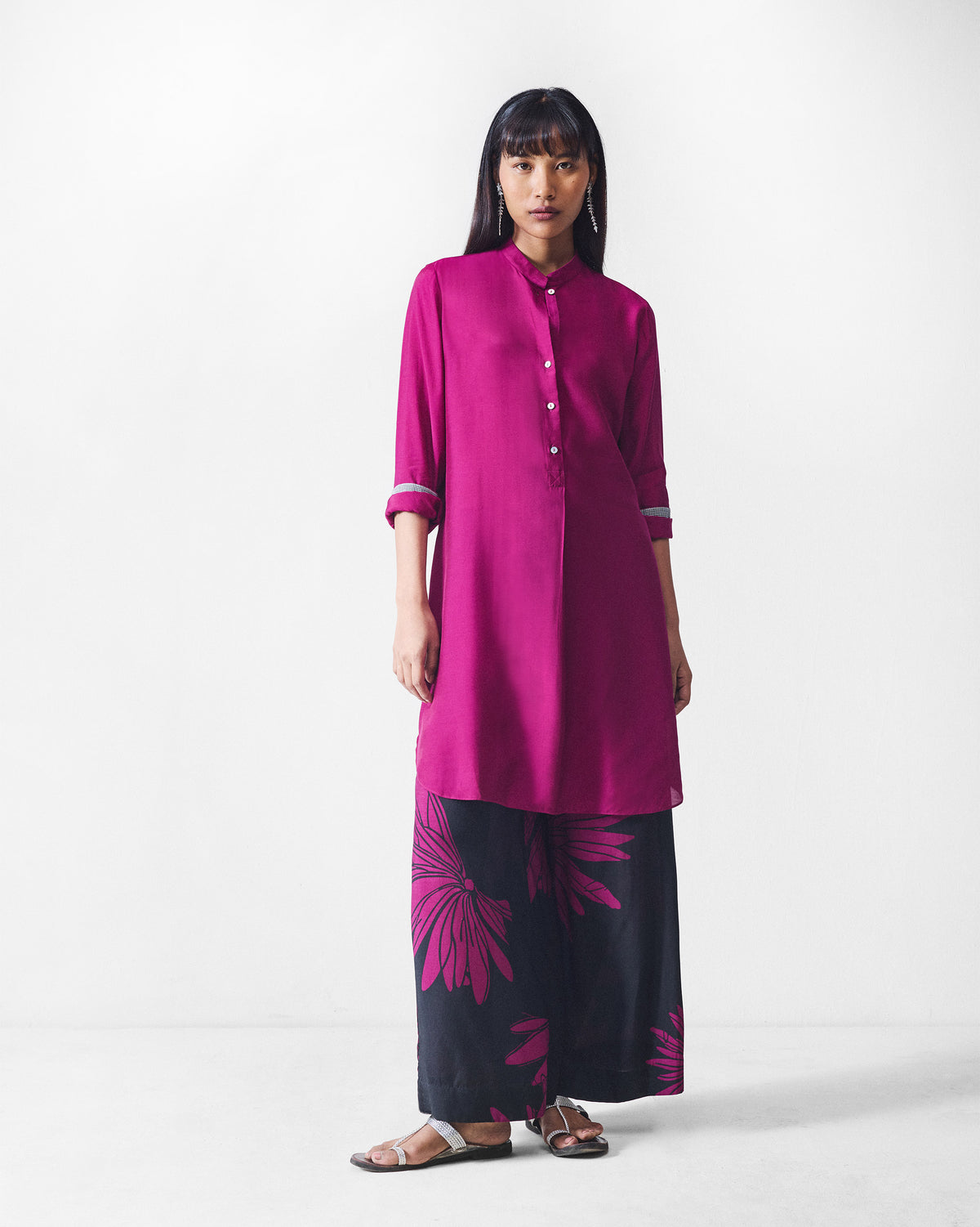 Person wearing black and mulberry printed Basic pyjamas with a magenta tunic.