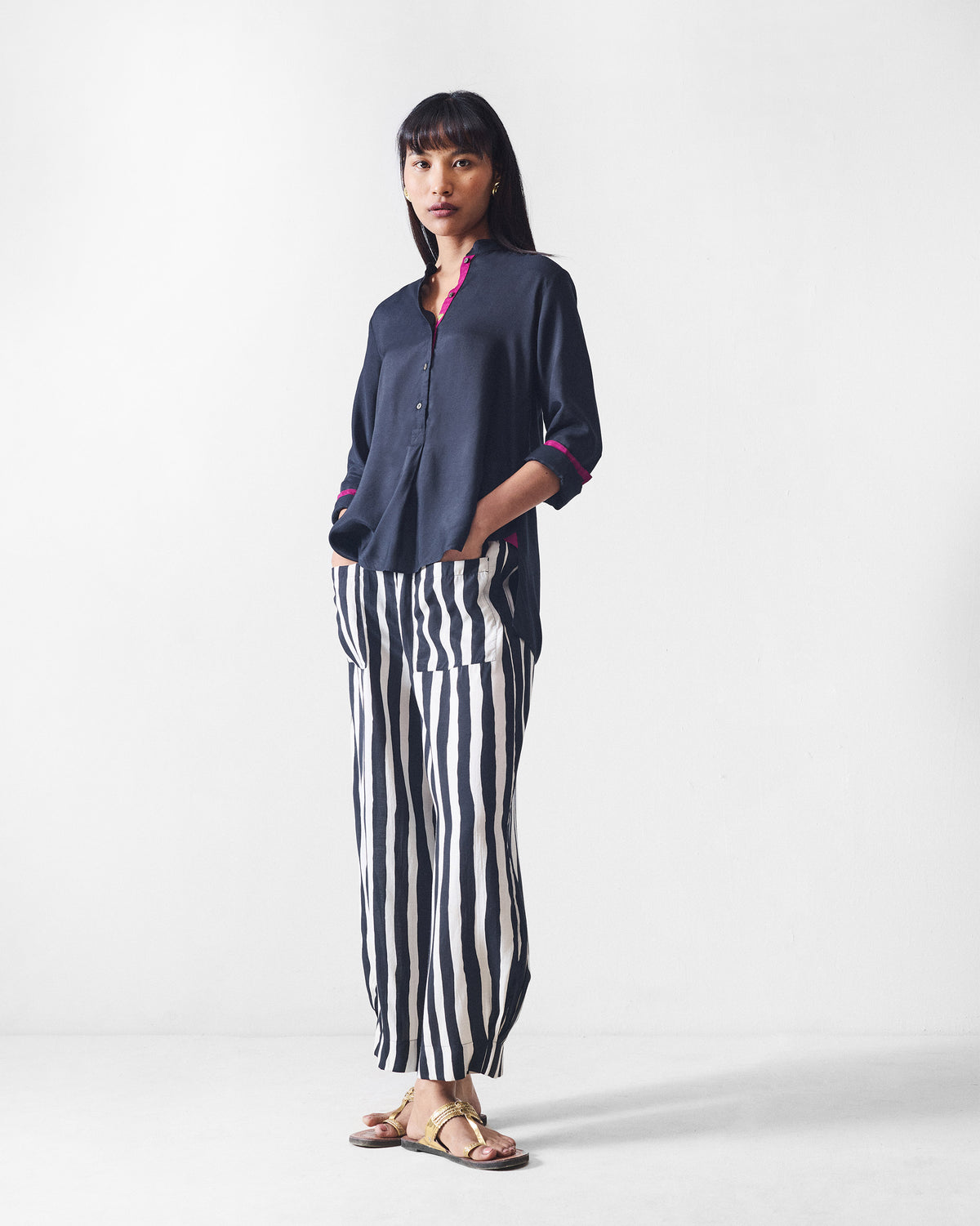 Person wearing black and beige printed serene pants with a wide-leg cropped hem.