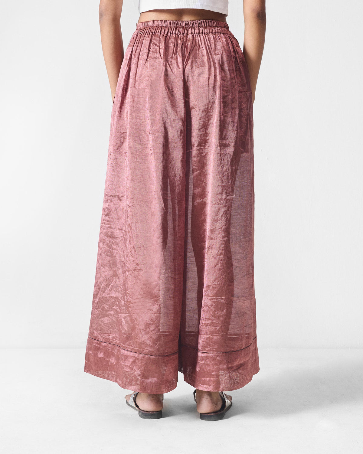 Back of metallic pink Charisma pants with a gathered waistband and wide hem.