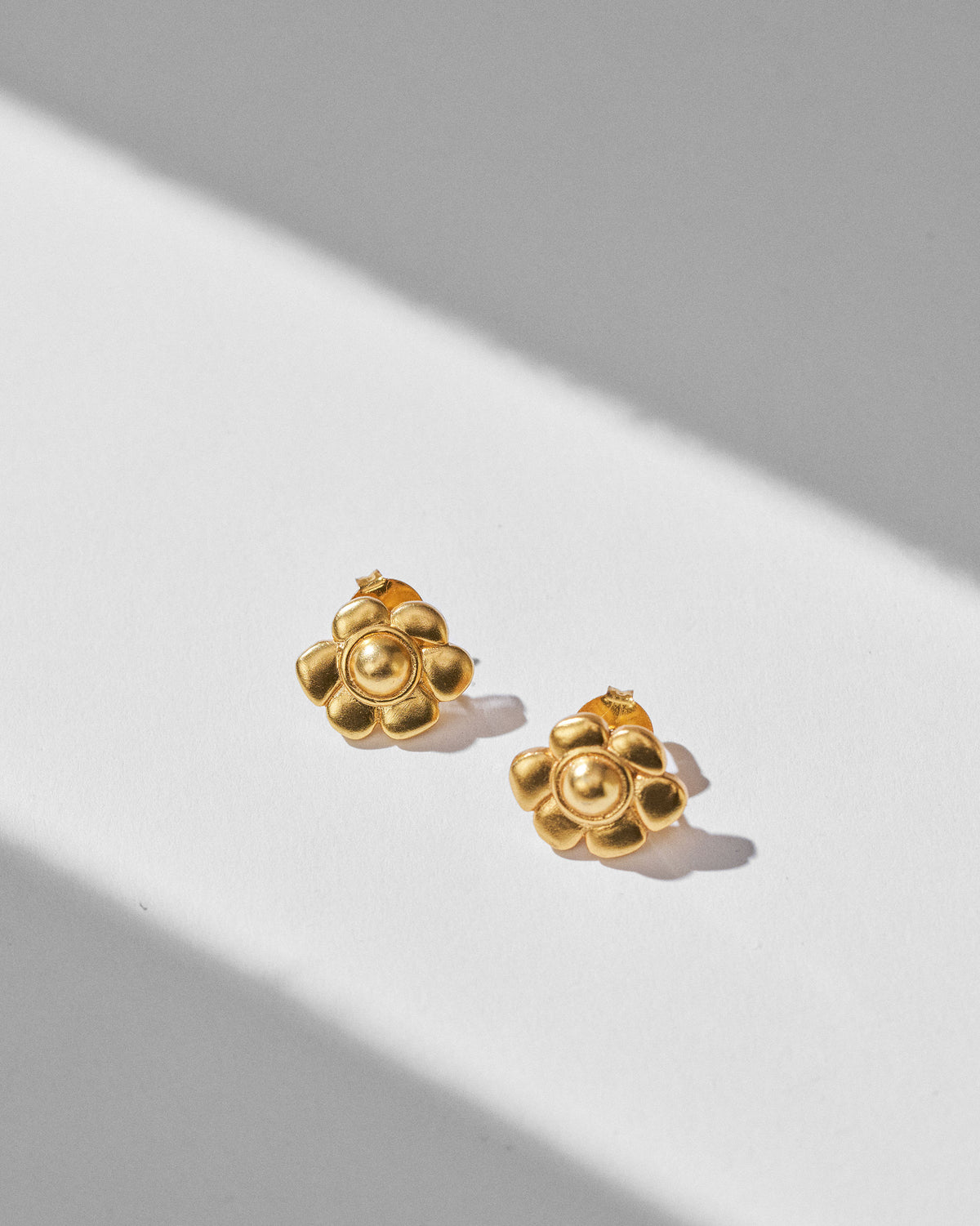 Pair of gold Daylily flower studs with rounded petals and domed centres.