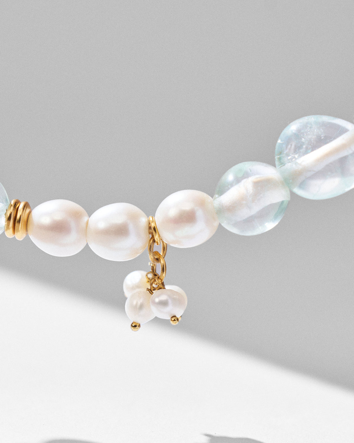 Close-up of pearls and pale blue beads on a Noorani necklace.