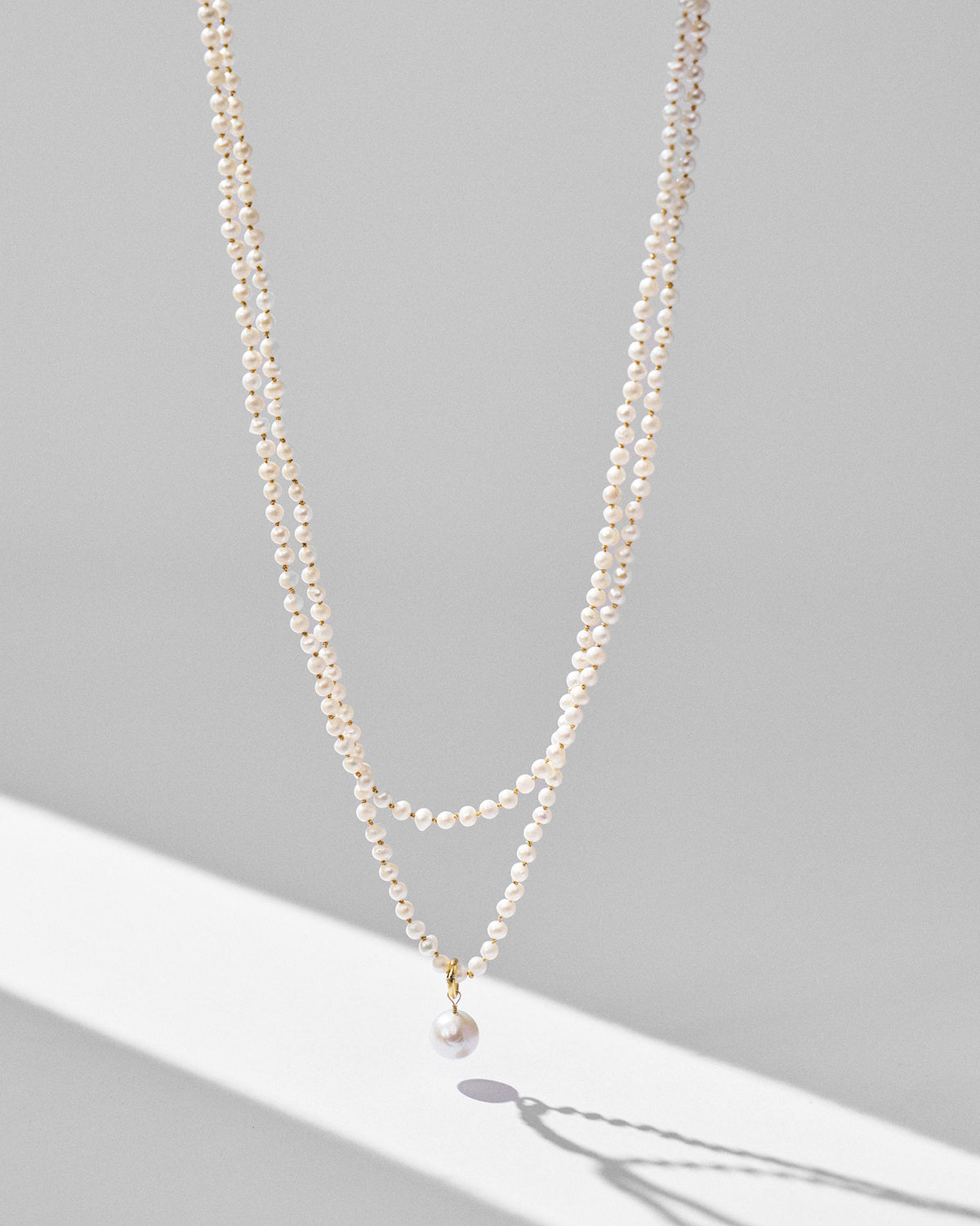Double-strand Chandni pearl necklace hanging to show its layered drape.