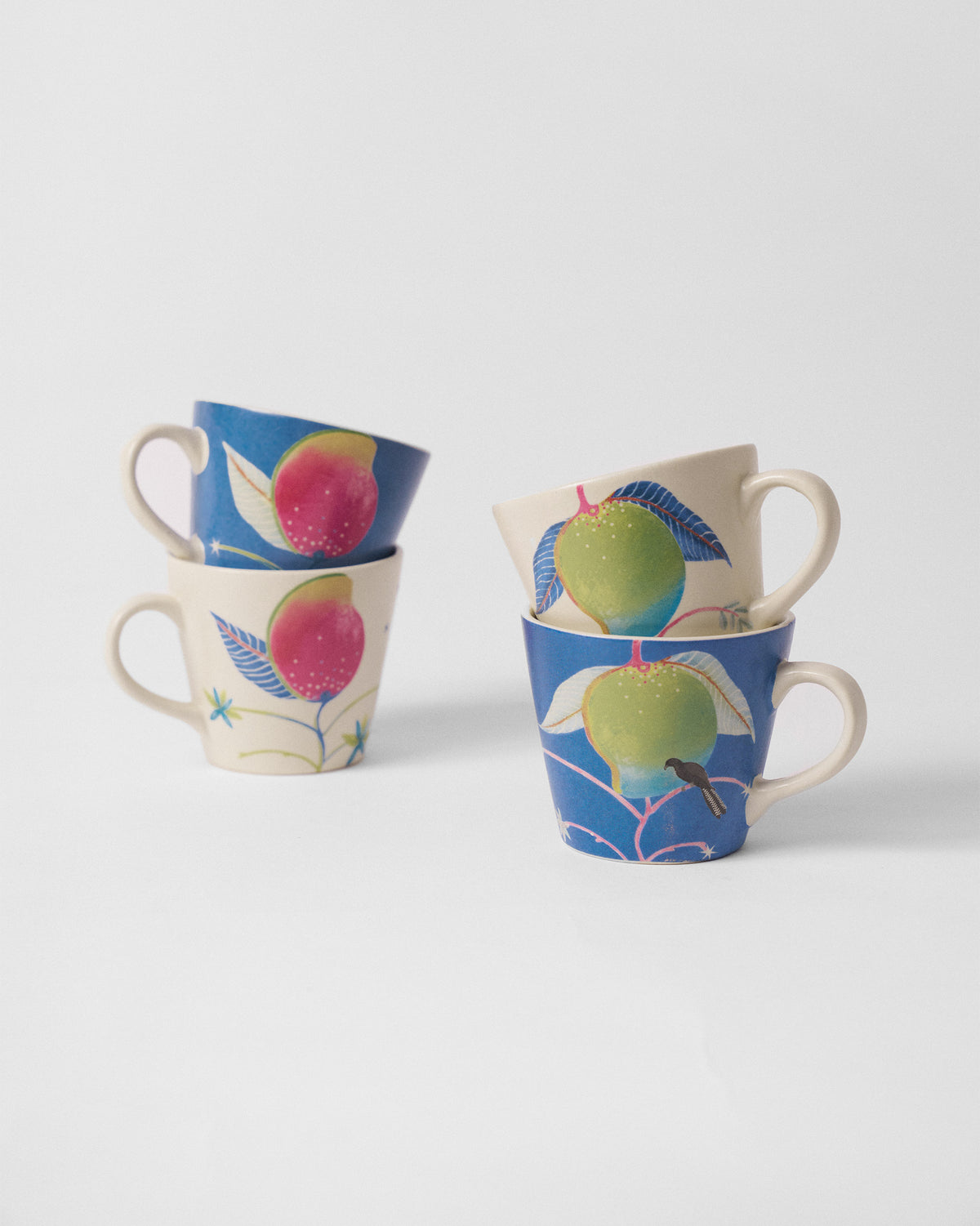 Ambi Espresso Mugs stacked in cream and blue with mango prints.