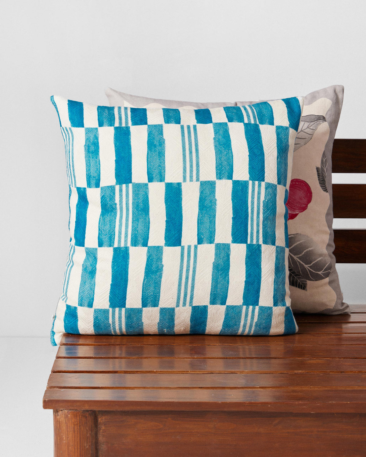 Blue Scallop cushion cover with blue and cream block stripes.