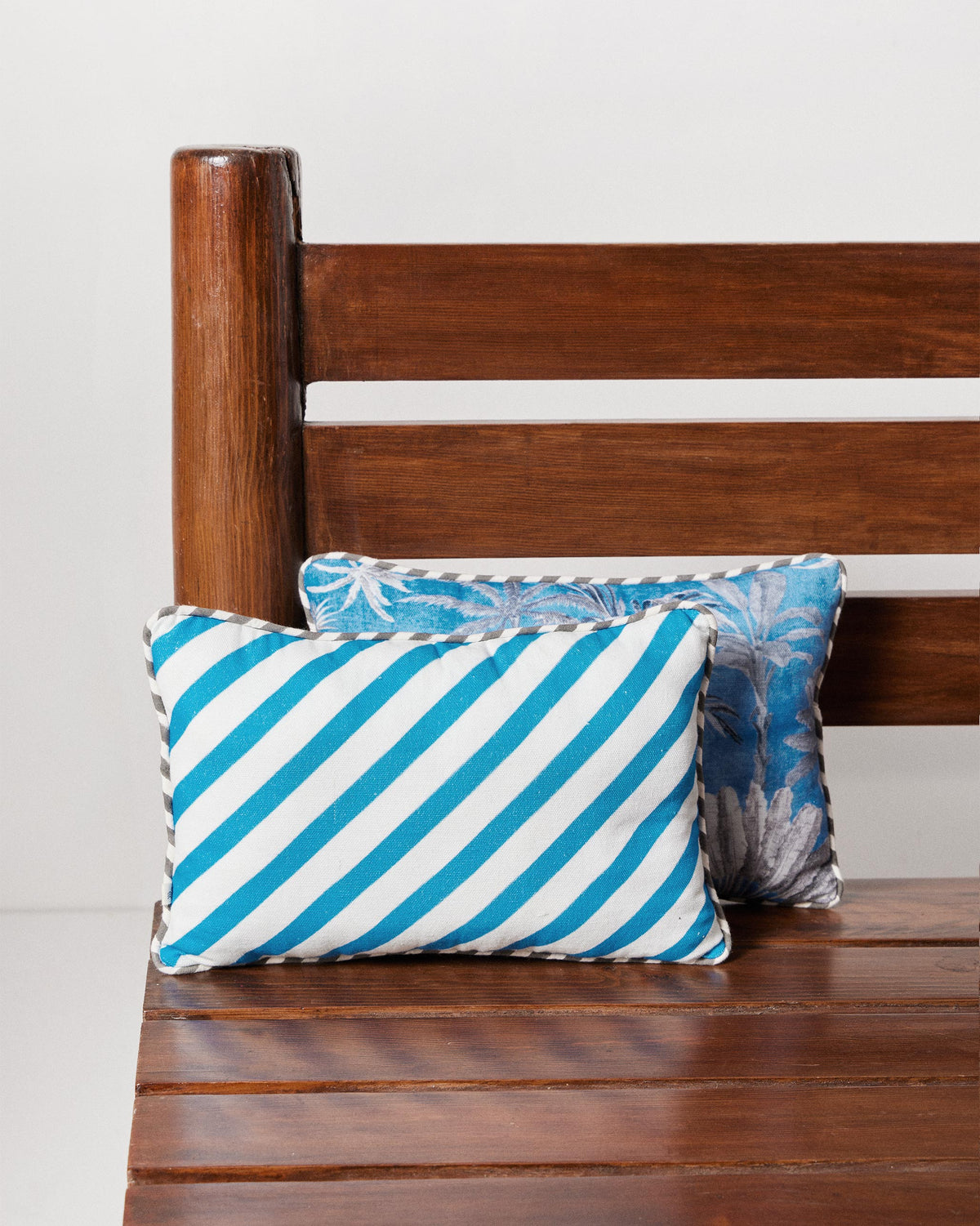 Sindhu car cushion with blue and white diagonal stripes.