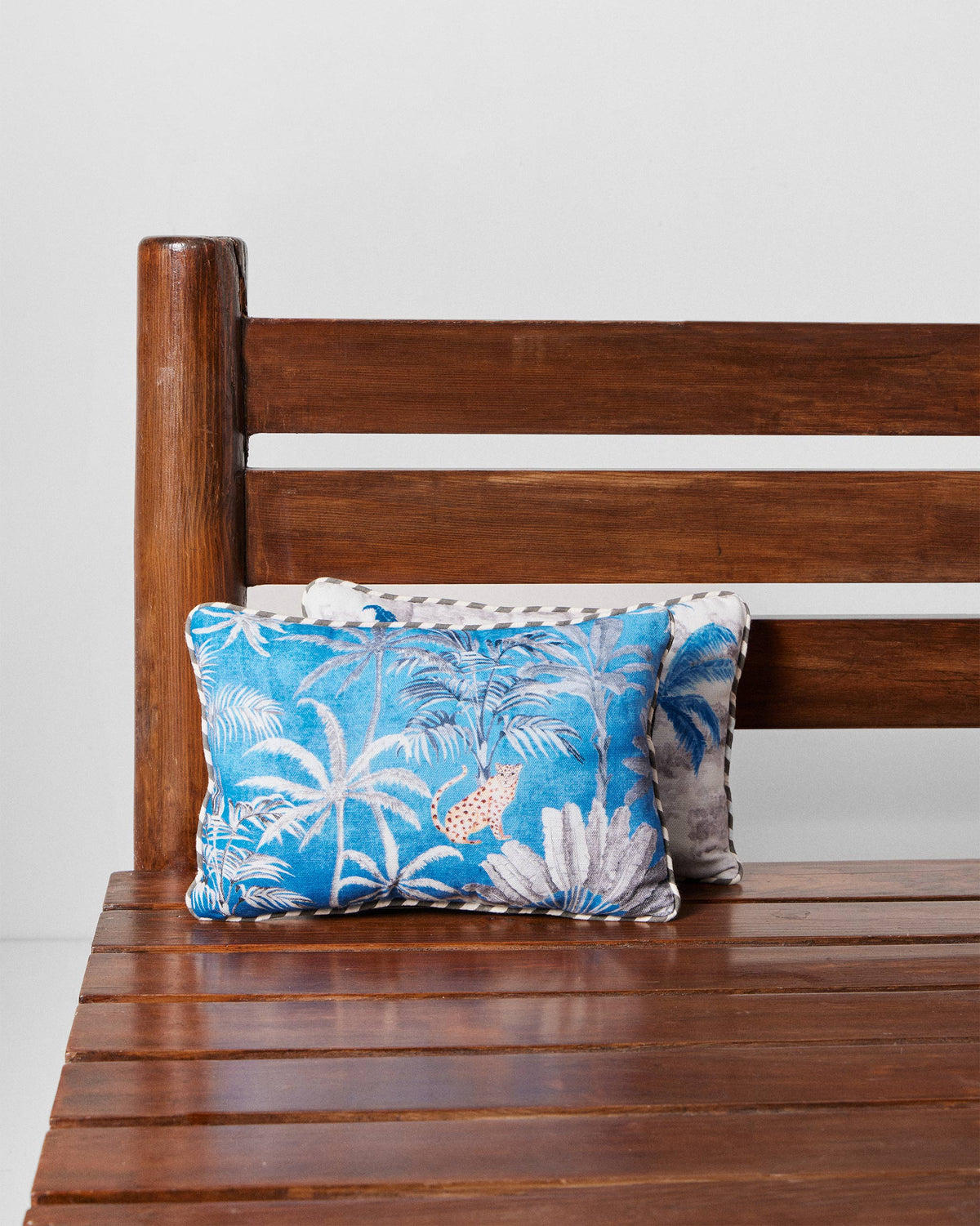 Sindhu car cushion in blue with palm trees and a leopard print.