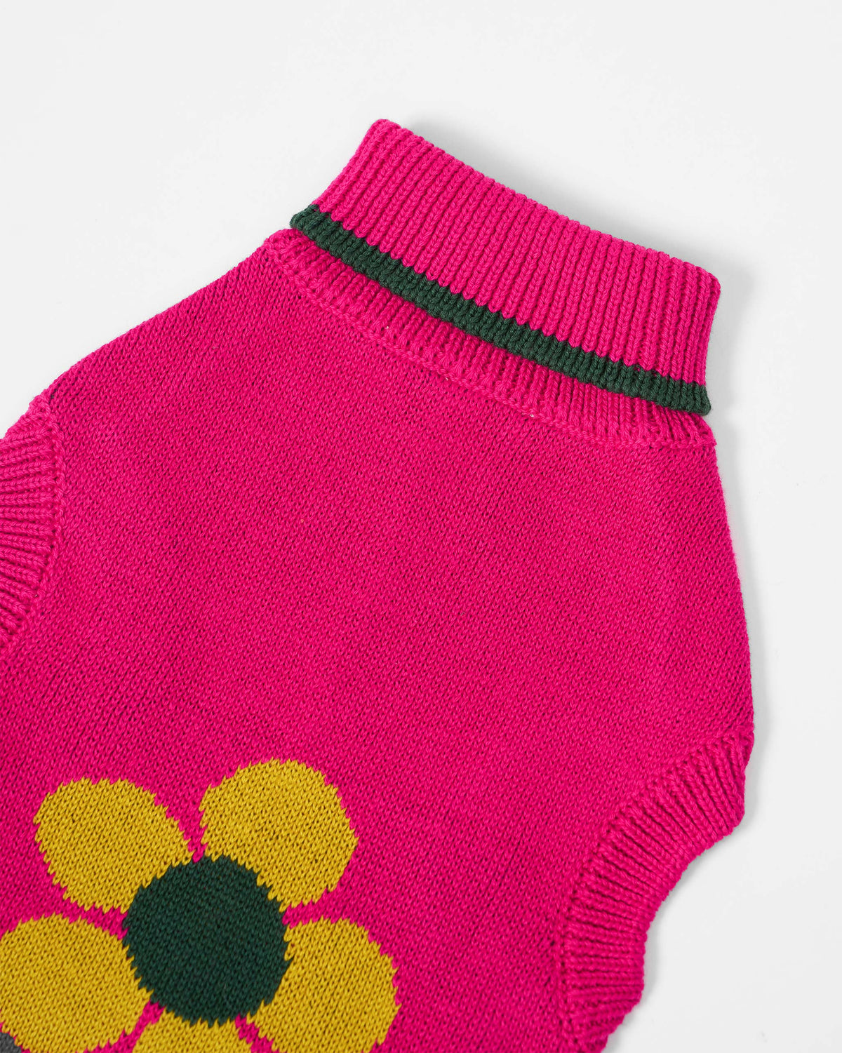 Close-up of a fuchsia Bark Bloom sweater showing the yellow flower.