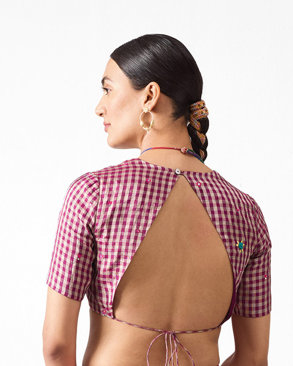 Back of magenta gingham Dori Blouse with a keyhole back worn by a person.
